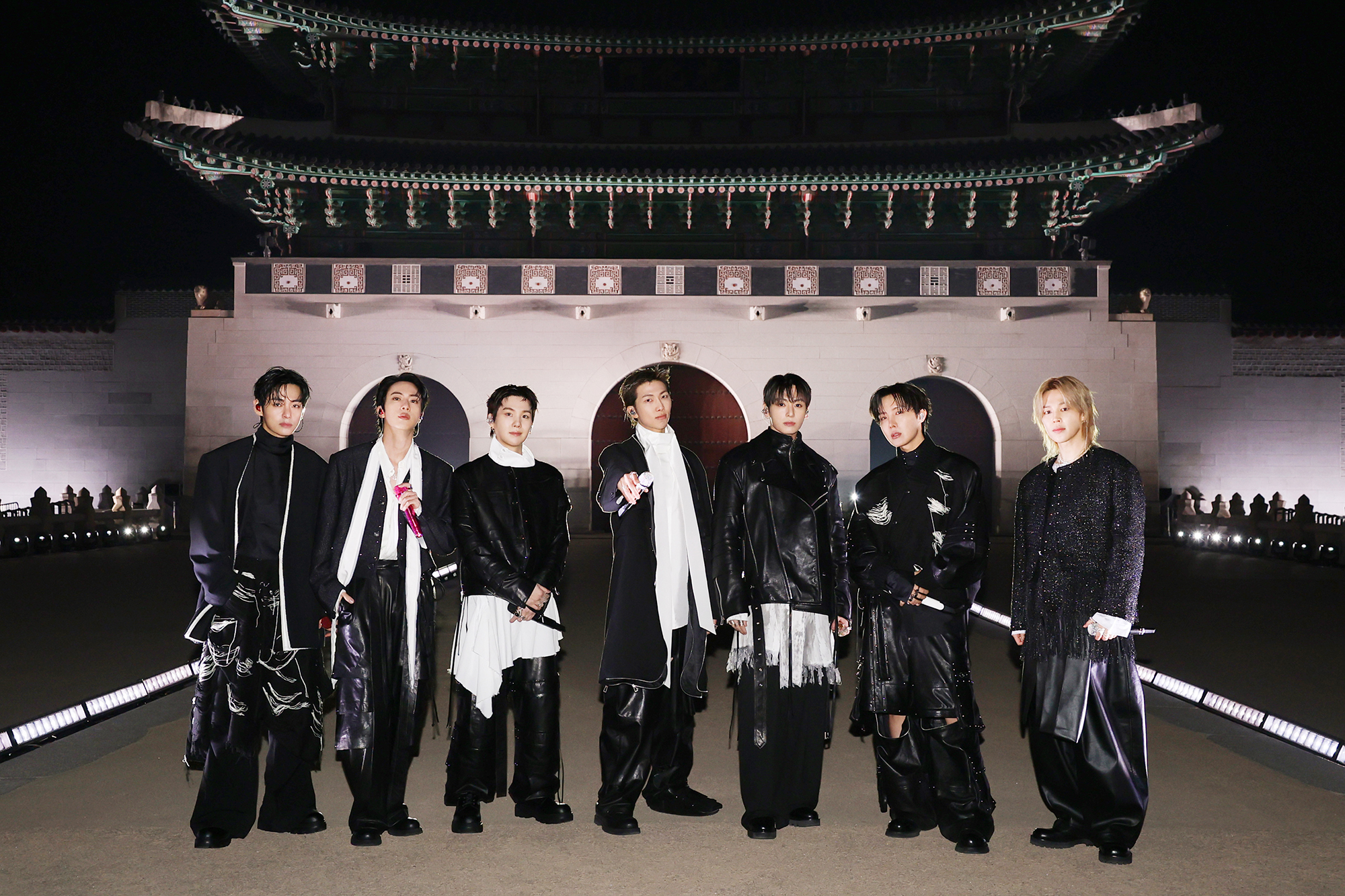 Members of the K-pop juggernaut BTS on March 21 stand on a woldae (elevated stone platform) before the group's performance at Gwanghwamun Gate in Seoul's Jongno-gu District. 