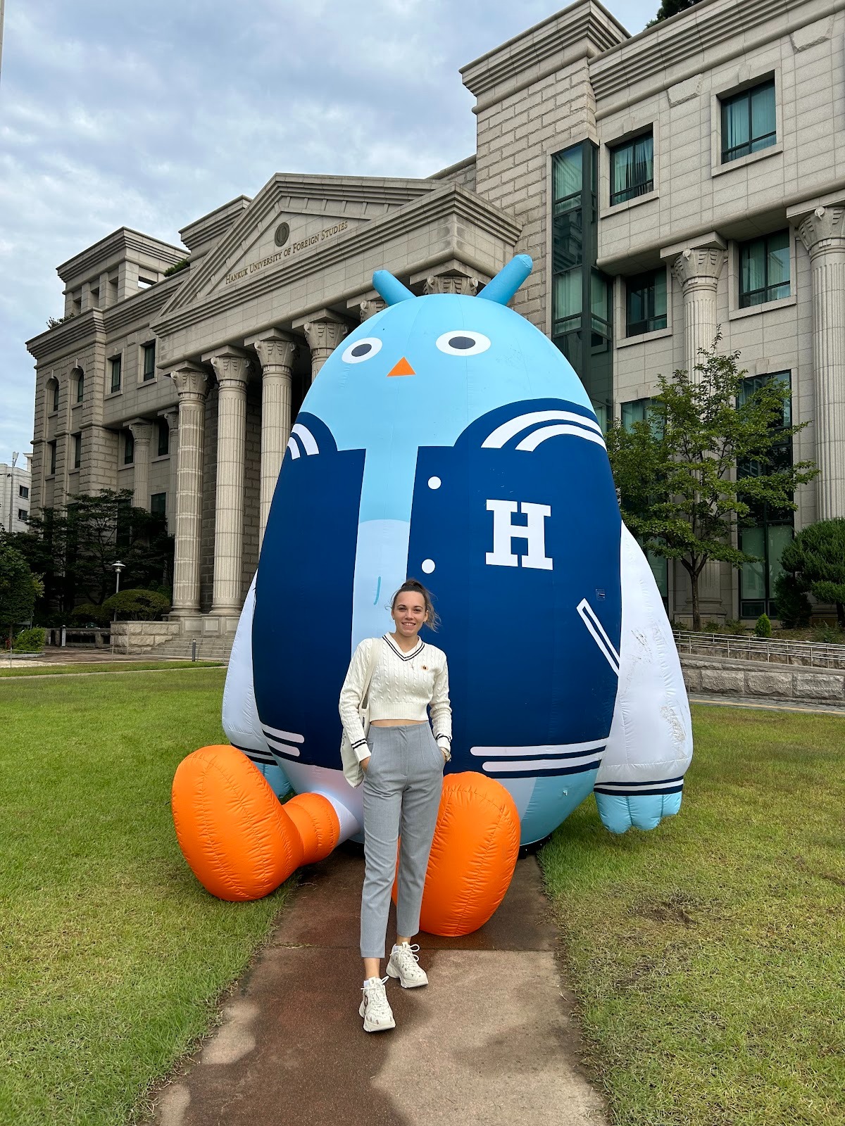 Snezana Mladenovic poses in front of the HUFS building beside the university’s blue bird mascot balloon during her first HUFS festival on Sep 21, 2023.