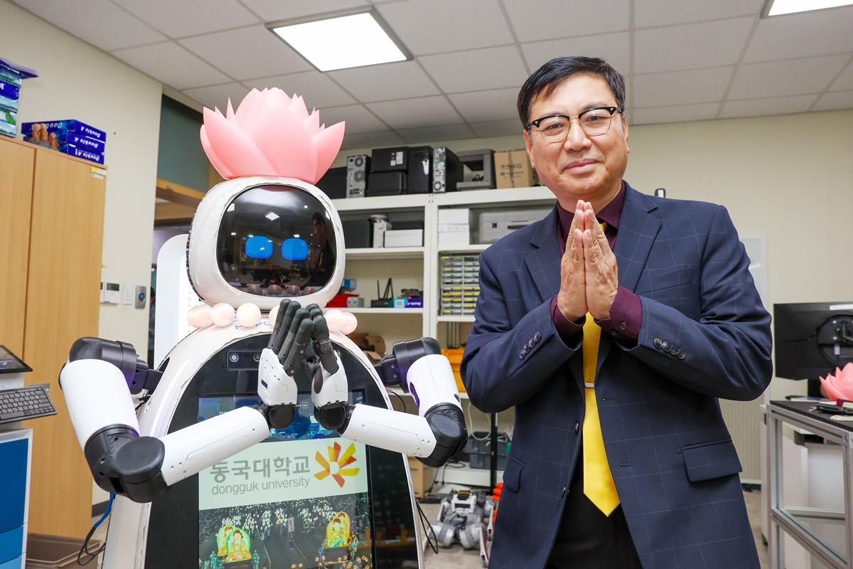 Ven. Hyean (left), the country's first artificial intelligence-driven robot Buddhist monk, and its developer Lim Joong-yeon, a professor at the Department of Mechanical, Robotics and Energy Engineering of Dongguk University, perform hapchang (anjali mudra), a traditional Buddhist hand sign of respect. 