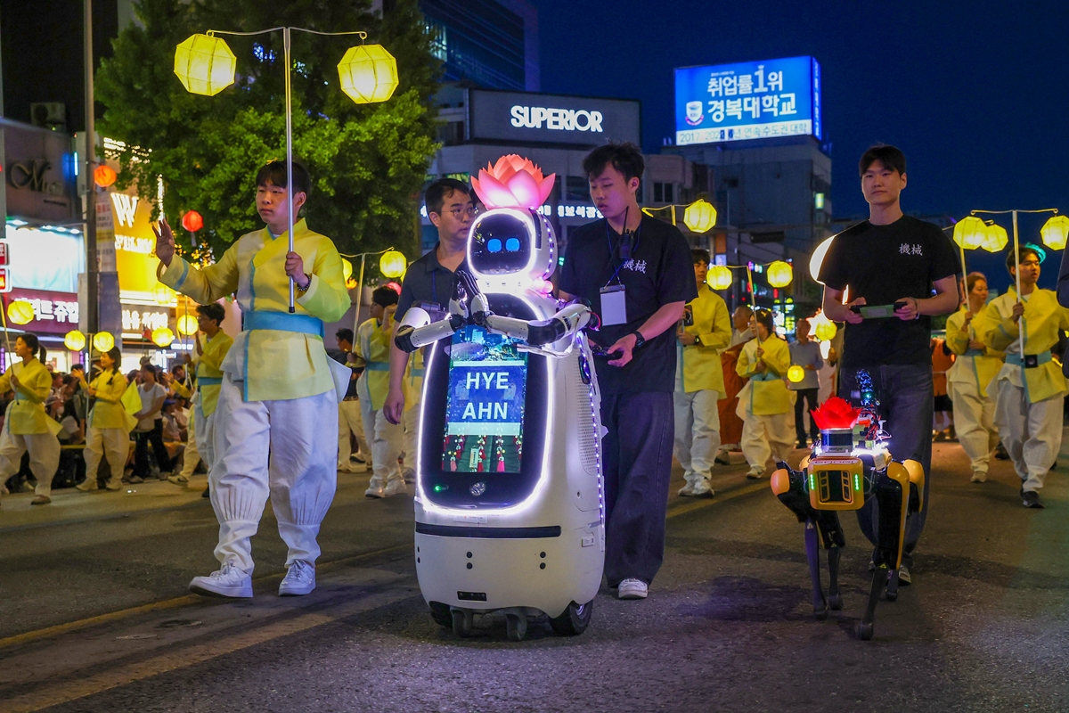 The AI-powered monk Ven. Hyean (left) and Googi (right), a four-legged patrol and safety robot equipped with multiple=