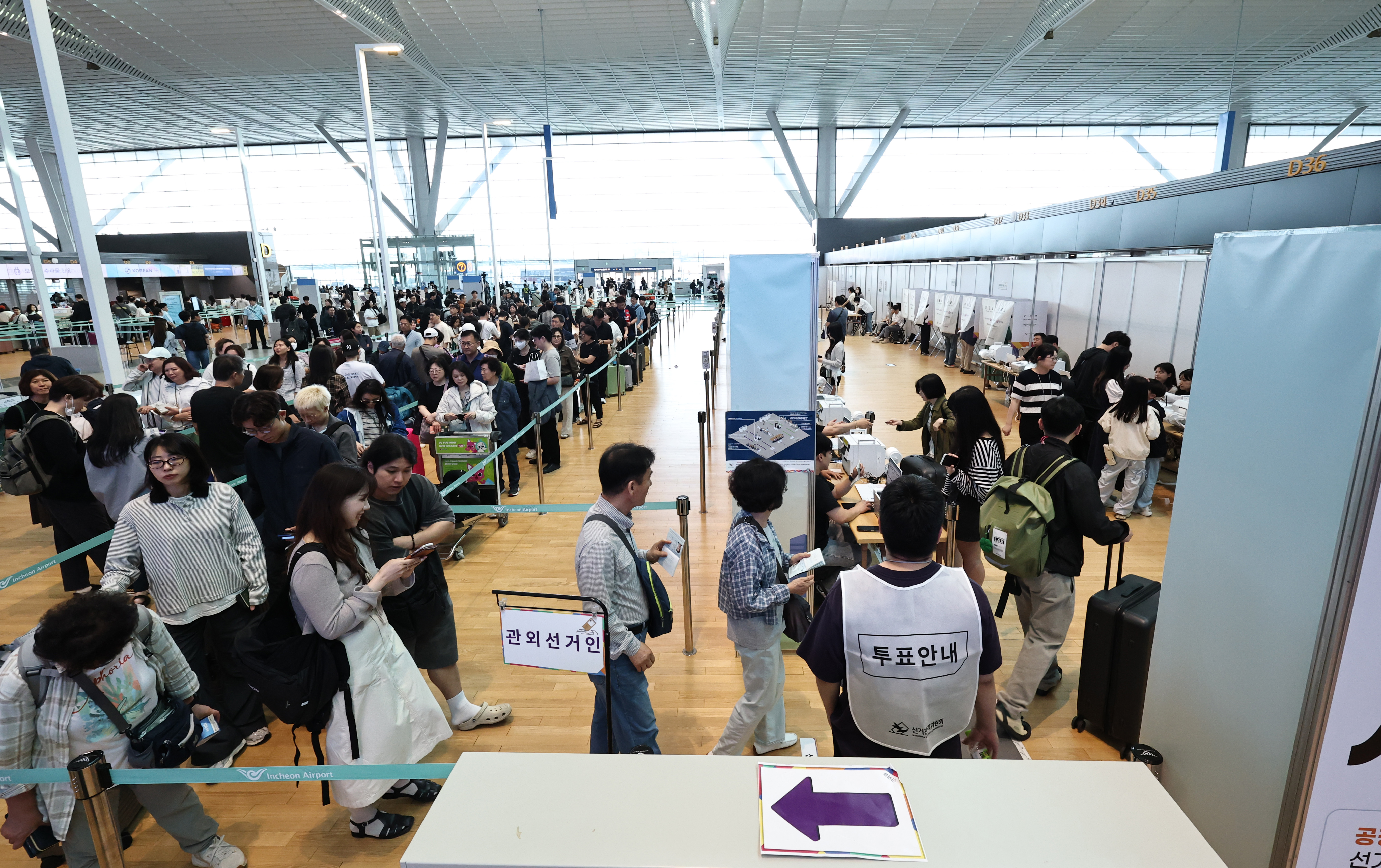 Voters on May 29, the first day of early voting for the June 3 local elections, line up to cast their ballots at a venue set up at the departure hall of Incheon International Airport's Terminal 2. (Yonhap News)  