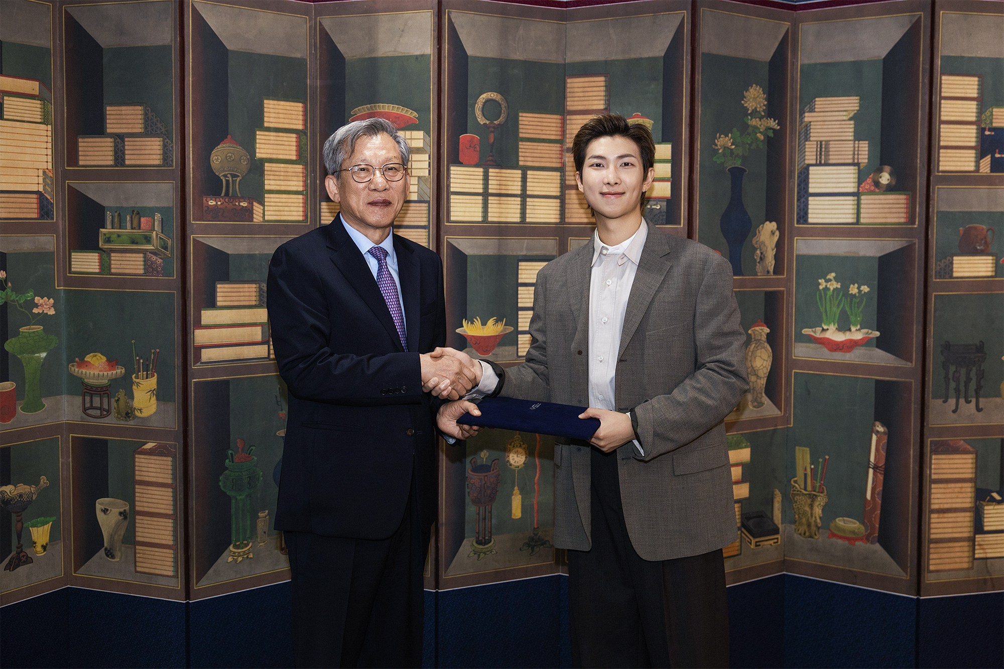 BTS member RM (right) on June 19 accepts his appointment as global ambassador for the National Museum of Korea in Seoul. 