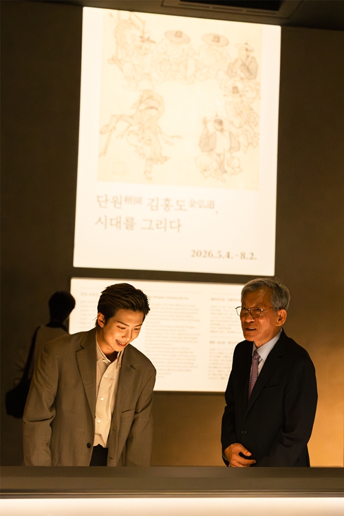 BTS member RM (left), newly appointed global ambassador for the National Museum of Korea, on June 19 looks at the exhibition 