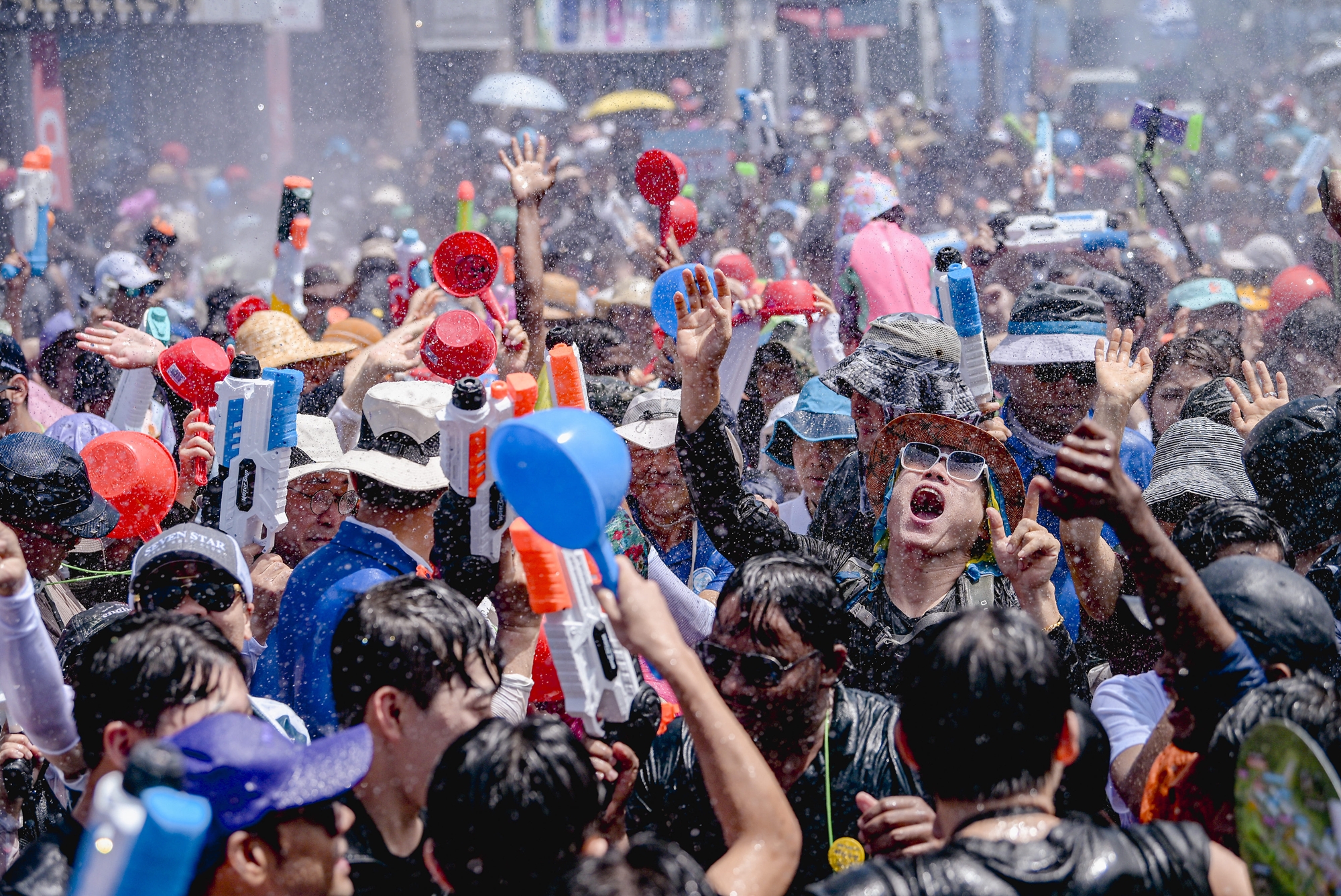 Crowds shoot their water guns at 
