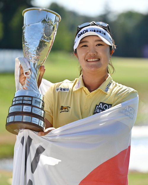 Ryu Haeran on July 12 smiles while holding her trophy after winning this year's LPGA Amundi Evian Championship at Evian Resort Golf Club in Evian-les-Bains, France.  
