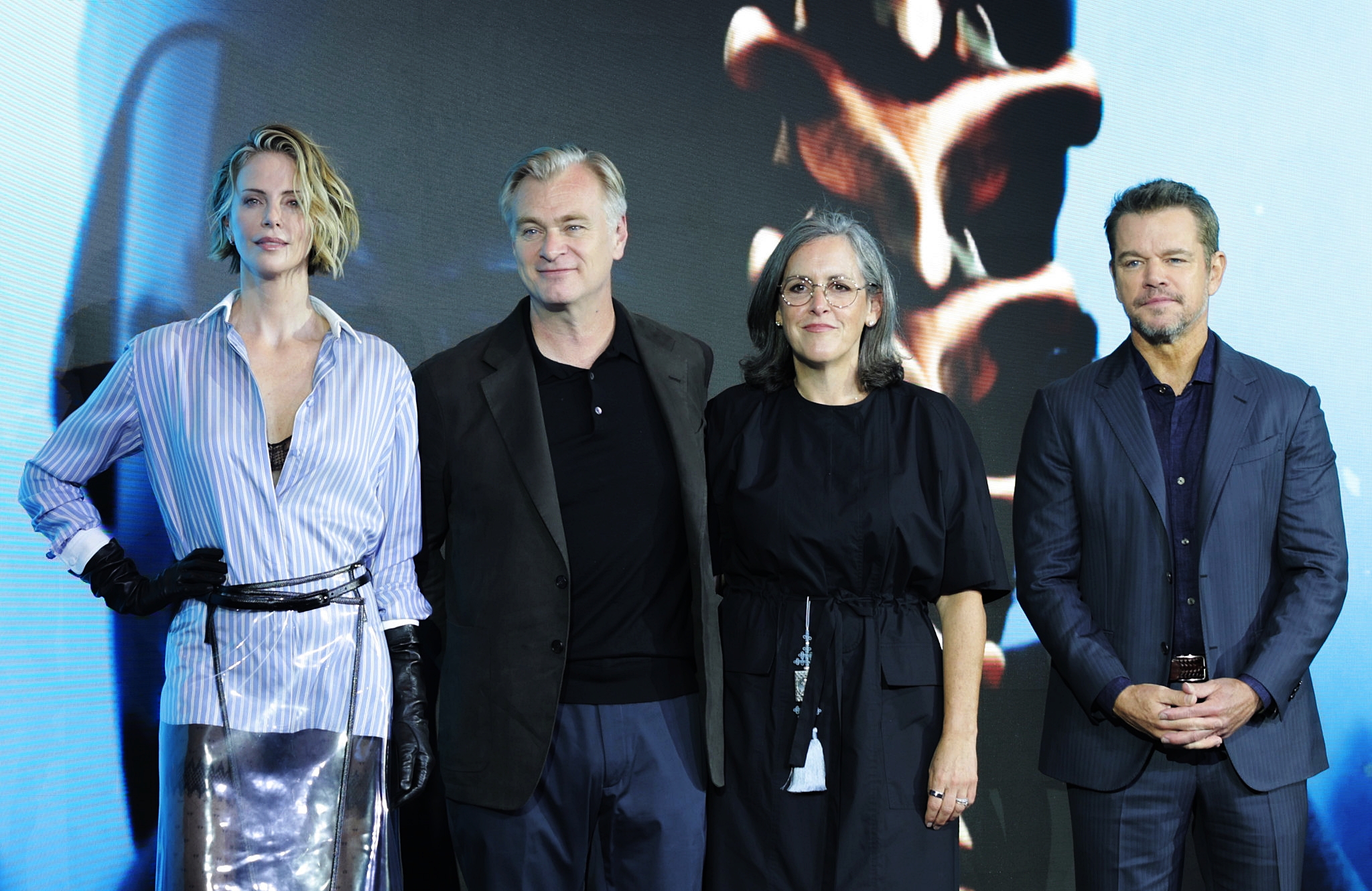 (From left) Actor Charlize Theron, director Christopher Nolan, producer Emma Thomas and actor Matt Damon on Aug. 3 pose for cameras at a news conference for their film 