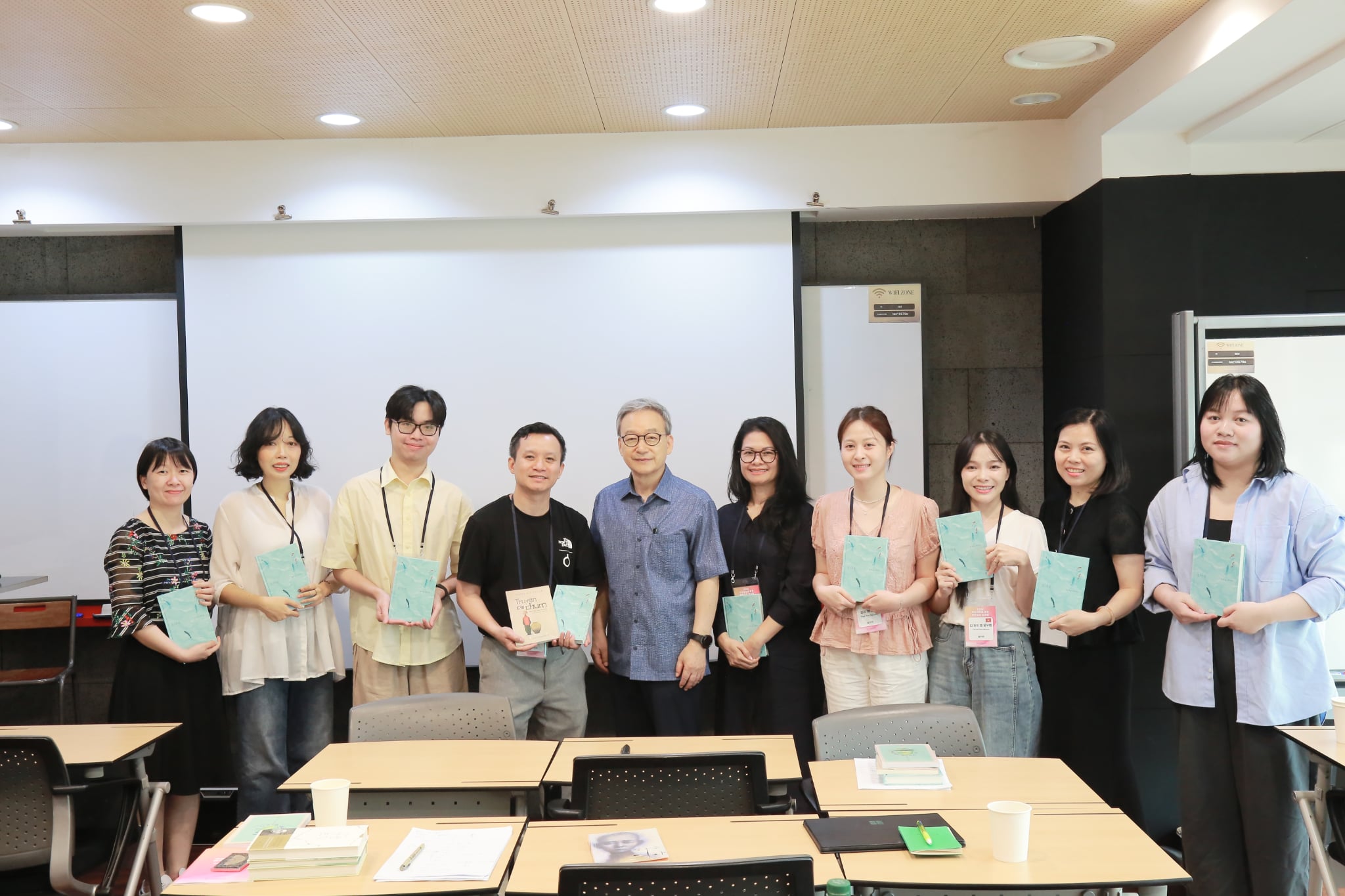Professor Nguyen Ngoc Que (fourth from left), head of this year's Vietnamese-language translation workshop, on July 28 poses for a group photo with participants in a 
