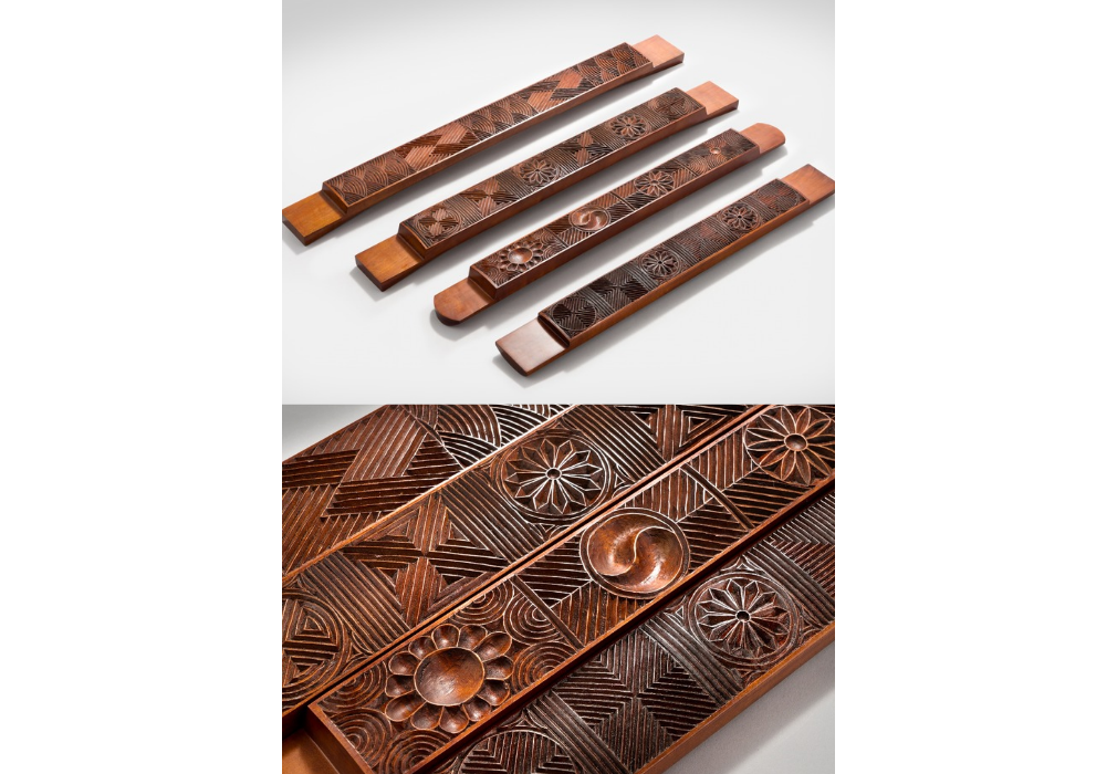 Rectangular tteoksal (rice cake molds) crafted in July 2024 by Kim display elaborate traditional motifs including Taegeuk (yin and yang symbol in red and blue) and floral patterns. (Courtesy of Kim Do-hyeong)