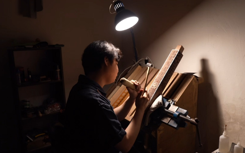 Master wood carver Kim Do-hyeong in May works on a wooden block. (Courtesy of Kim Do-hyeong)