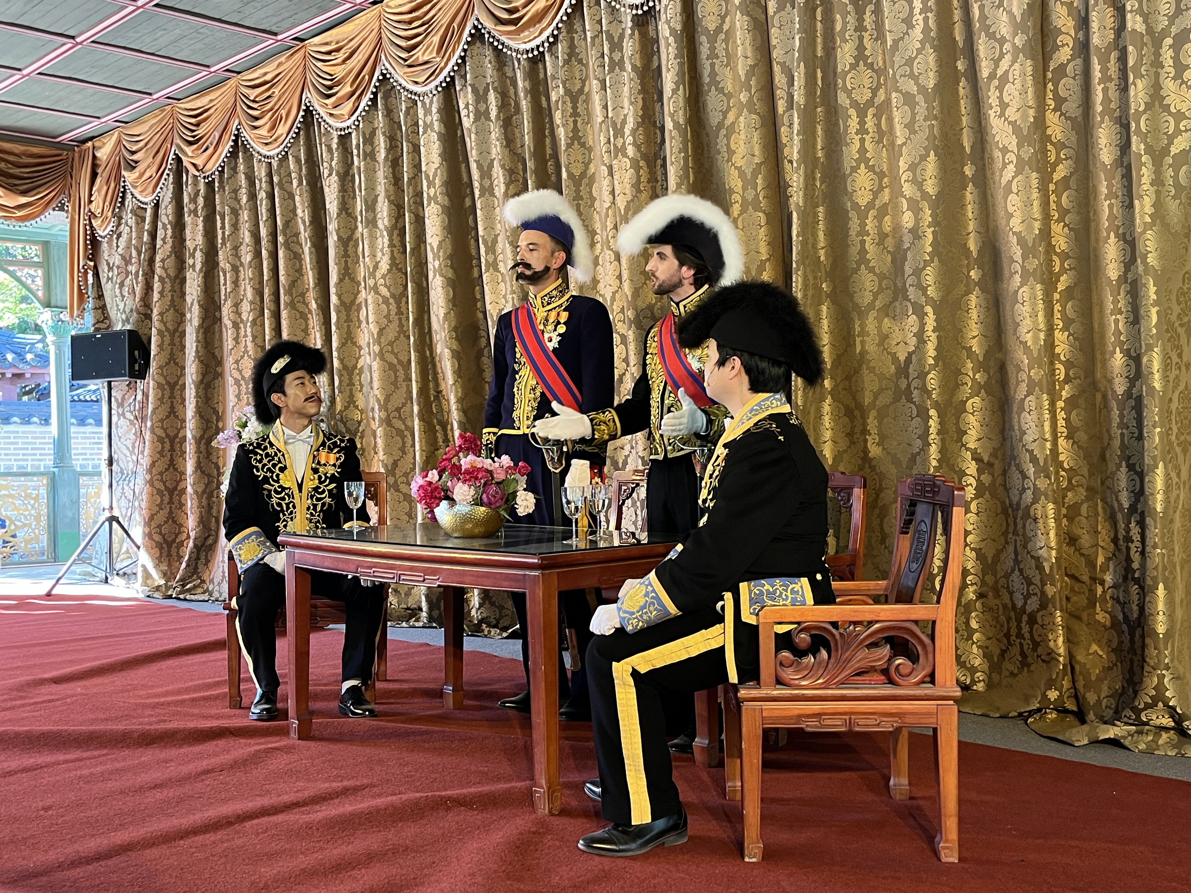 From left are actors portraying Hyun Sang-geon, a diplomat and closer adviser to Emperor Gojong fluent in French; French Minister Victor Collin de Plancy; British Charge d'Affaires John Harington Gubbins; and empire diplomat Lee Han-eung at Jeonggwanheon Pavilion of Deoksugung Palace in Seoul..