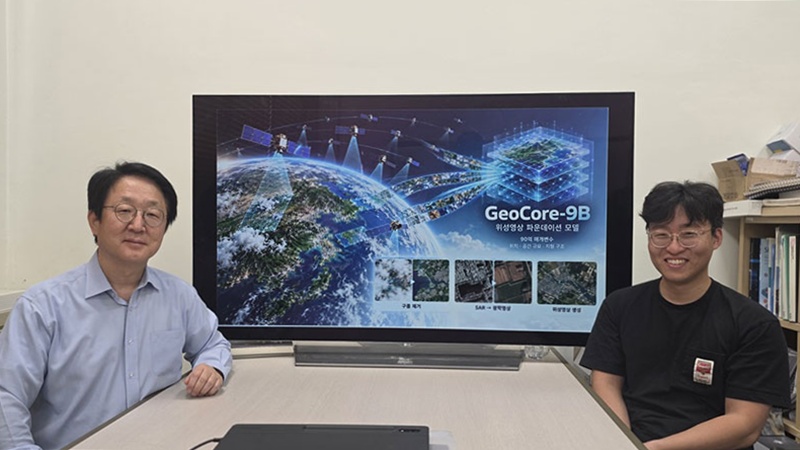 A research team at the Korea Advanced Institute of Science and Technology (KAIST) has developed GeoCore-9B, an artificial intelligence model for the generation, restoration and transformation of satellite imagery. Shown are professor Kim Munchurl (left) from KAIST's School of Electrical Engineering and the study's lead author Do Jeonghyeok sitting in front of a large screen displaying their team's achievements.