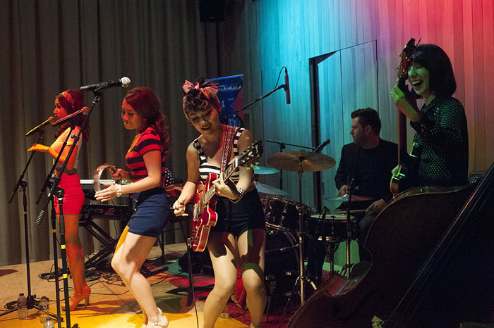 The three-member band The Barberettes performs '50s rock songs in a small theater in London on Sept. 5.