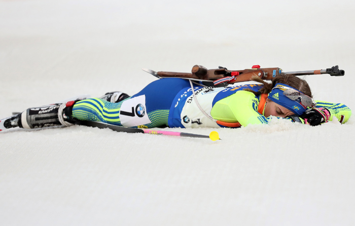 Anna Magnusson of Sweden lays exhausted on the ground after losing the third rank by Italy the women’s relay in the BMW IBU Biathlon World Cup, at the Alpensia Biathlon Center in Pyeongchang, Gangwon-do Province, on March 5.
