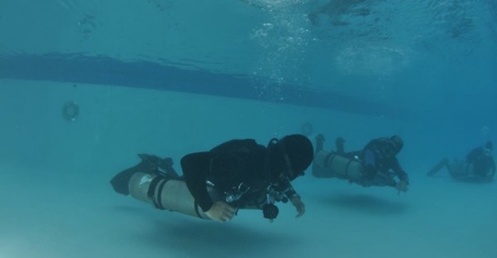 Basic scuba diving lessons are simulated first in a swimming pool