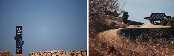 (Left) A road sign tells you that you are on a Slow Path. (Right) From Cheonghaejin, you can see the outer castle gate below.