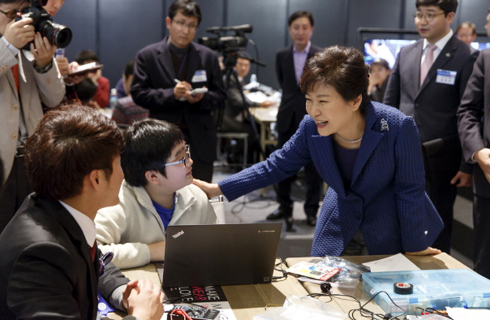 President Park Geun-hye (right) greets a young visitor to the ongoing Creative Korea 2014 conference at COEX in Seoul on November 27. 