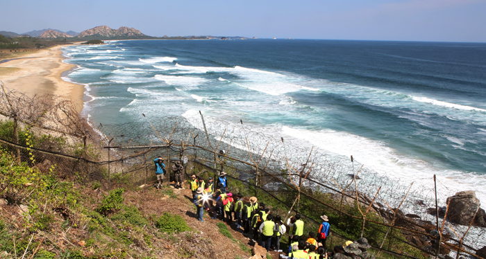 Visitors on April 27 walk along a fortified coastal road known as the DMZ Peace Trail in Goseong-gun County, Gangwon-do Province. The trail has been opened to the public for the first time in 65 years.