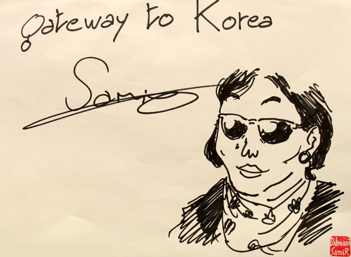 Dahmani signs his autograph with a drawing of a typical Korean woman, or '<i>ajumma</i>.' He says he enjoys drawing the Korean female face.