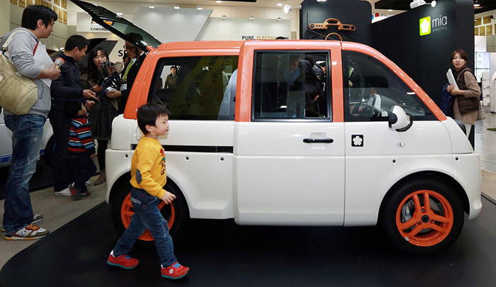 People look around France-based Mia Electric's Mia EV at the International Electric Vehicle EXPO. (courtesy of the International Electric Vehicle EXPO)