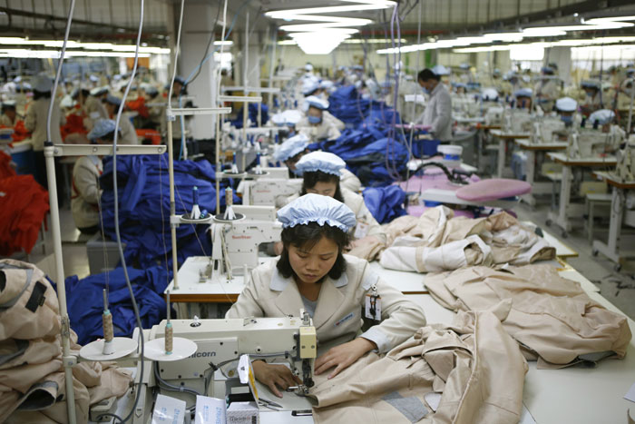 South Korea said on Dec. 10 that it will halt operations at joint industrial park with North Korea in response to the North's recent rocket launch. North Korean workers assemble jackets at a factory of a South Korean-owned company at the jointly-run Kaesong Industrial Complex.