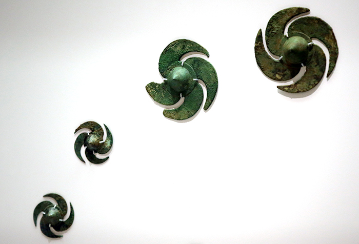 Pinwheel-shaped bronze shield ornaments attest to Gaya's active international trade.