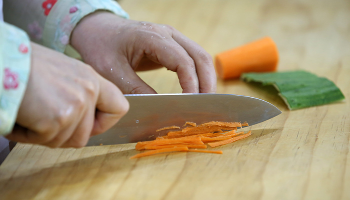 Slice each ingredient -- the beef, cucumbers, carrots, mushrooms, eggs -- as thinly and evenly as possible.
