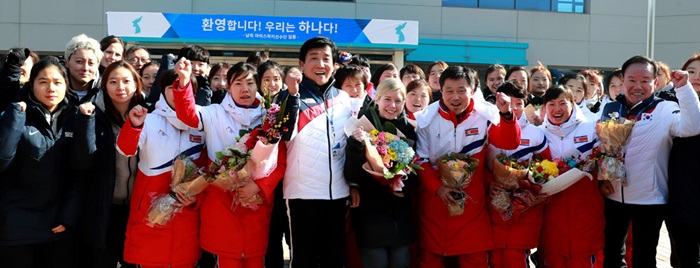 The South and North Korean women’s ice hockey teams shout, ‘We are one!’ together after the North team arrives at the Jincheon National Training Center in Jincheon, Chungcheongbuk-do Province. (Korean Sport & Olympic Committee)