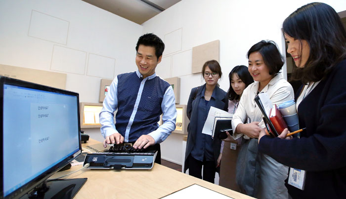 A stenographer types on a computer screen in Korean. Visitors to the National Hangeul Museum learn about the 'informatization' of Hangeul in a new special exhibit there, ‘A New Name in a Digital World, Code-Named_Hangeul: D55CD AE00.’