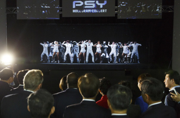 Participants watch a hologram of the 'Gangnam Style' music video by Psy during the ITU Plenipotentiary Conference at BEXCO in Busan on October 20.