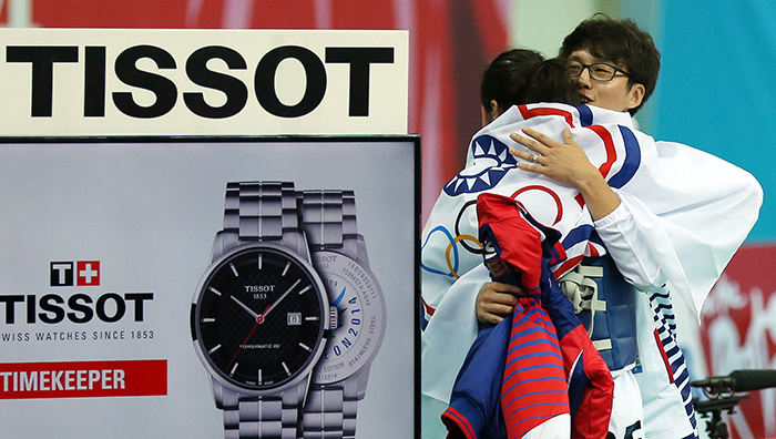 Coach You Young Dae hugs Taiwanese athlete Huang Yun Wen after she wins the women’s taekwondo 53 kilogram event on September 30 during the Incheon Asian Games 2014.