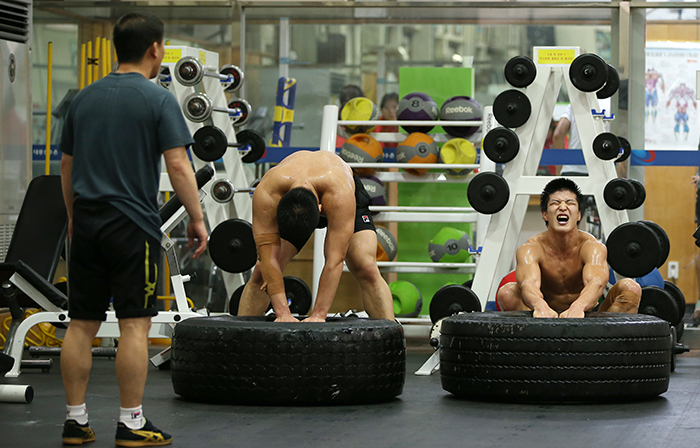 Korean national wrestlers train hard with sweat at the Korea National Training Center in Taeneung, Seoul, on August 20.