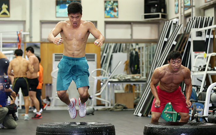 Wrestlers are drenched with sweat while doing a physical training routine at the Korea National Training Center in Taeneung, Seoul, on August 20.