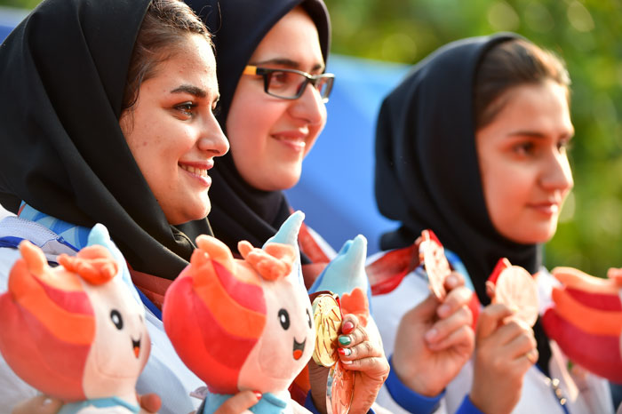 Iranian shooters pose for a photo while showing off the medals they won on July 5.