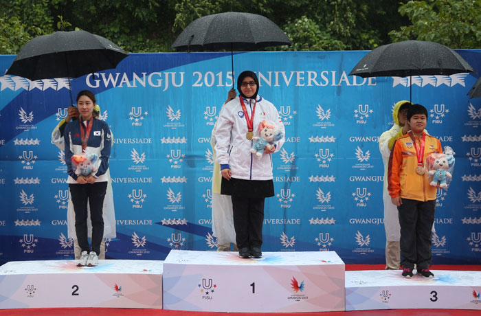 Jambozorg Mahlagha (center) wins gold in the 50-meter rifle prone competition on July 6, followed by her rivals from Korea and Thailand.