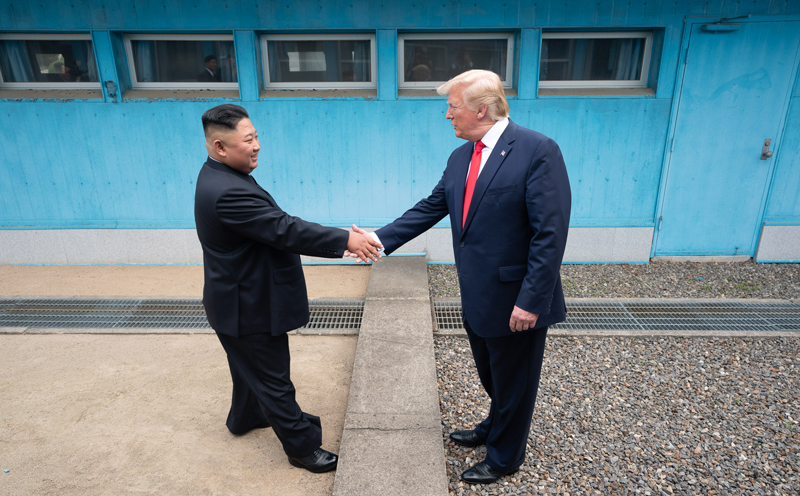 U.S. President Donald Trump and North Korean leader Kim Jong Un on June 30 shake hands over the Military Demarcation Line in Panmunjeom on the inter-Korean border. (White House)
