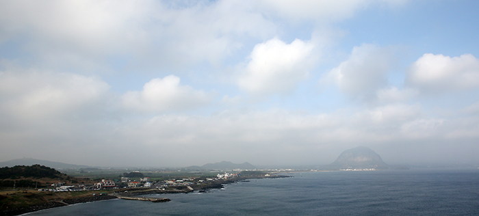 The Sanbangsan outcropping is surrounded in mist, as seen from the middle of Olle Trail No. 10.