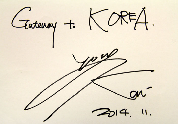 Singer and stage actor KAI signs an autograph for Korean.net readers.