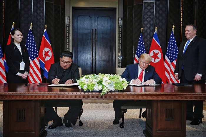 North Korea’s Chairman of the State Affairs Commission Kim Jong Un (left) and U.S. President Donald Trump sign a joint agreement at the Capella Hotel in Singapore where they held a summit on June 12.