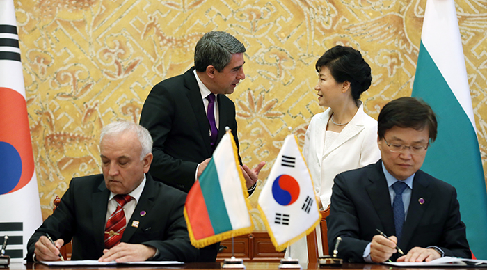 Minister of Science, ICT and Future Planning Choi Yanghee (right) and Bulgarian Deputy Minister of Education and Science Kostadin Kostadinov sign an MOU to cooperate on science and technology, at Cheong Wa Dae on May 14. President Park and her Bulgarian counterpart hold a conversation behind them.