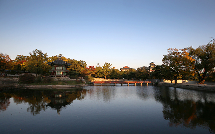 The Hyangwonjeong Pavilion at Gyeongbokgung Palace in Seoul adds to the aura of autumn as the red and yellow leaves on nearby trees lining the pond contrast with the cloudless blue sky overhead, on October 15.  
