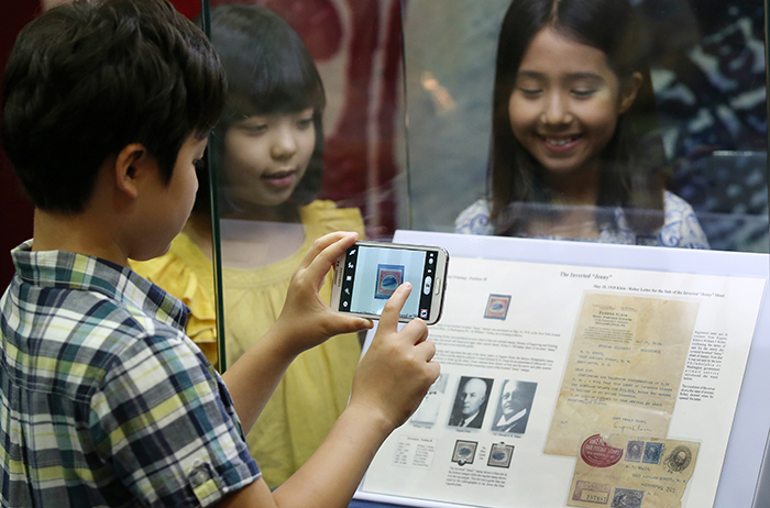 A rare stamp, the Inverted Jenny, is a U.S. stamp of a Curtiss JN-4 airplane. It attracts the attention of many young people visiting the PHILAKOREA 2014 World Stamp Exhibition. (photo: Jeon Han)