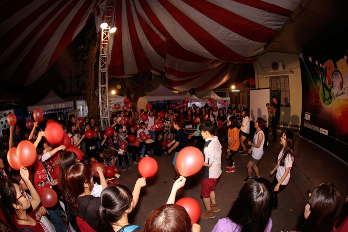 Members of a Korean pop music fan club enjoy performances put on by their peers.