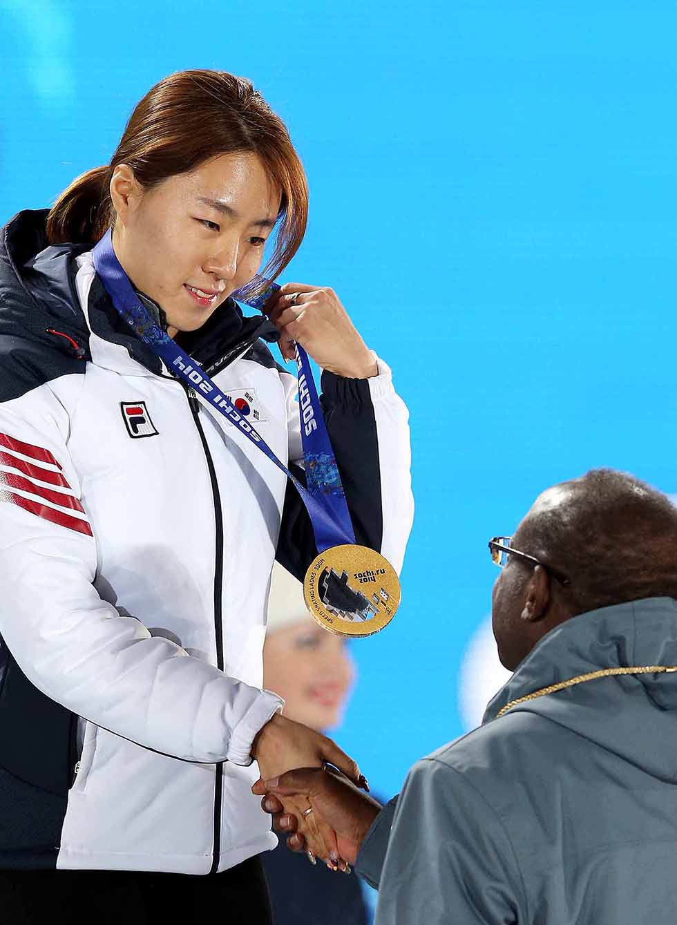 Speed skater Lee Sang-hwa shakes hands with the presenter during the award ceremony at the Sochi Medals Plaza, near the Coastal Cluster of Olympic venues, in Sochi on February 12. She won gold in the ladies' 500-meter speed skating race with a new Olympic record. (photo courtesy of the Korean Olympic Committee)