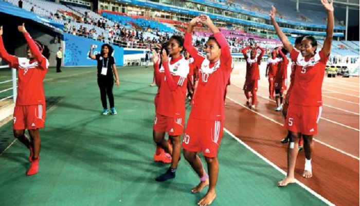 The Maldives’ women's football team waves to spectators after a match. 