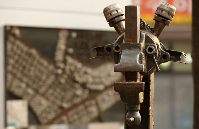 Sculptures welcome visitors to a street of iron mongers and art galleries in Mullae-dong.
