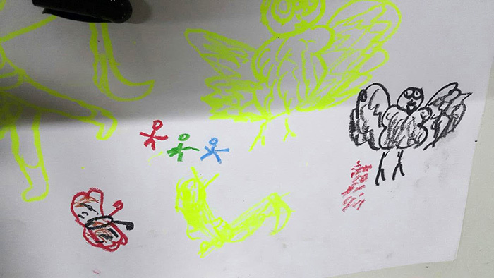 Soe Htat, one of Maung Tai Aung’s children, draws his dream of becoming a bird so that he could fly away and leave the refugee camp.