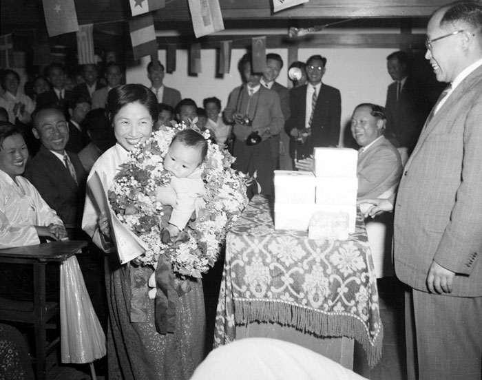 A mother and her baby pose for a photo during a 1959 contest to choose the healthiest baby. As many people weren't well-off at the time, raising a 'perfect' baby was the envy of many.