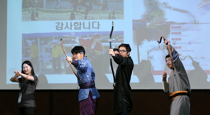 The <i>Saesangae Masangae</i> team (세상에 마상에), consisting of students from Korea, Mongolia and Uzbekistan, pose like archers. The team gave a presentation on traditional Korean horseback martial arts.