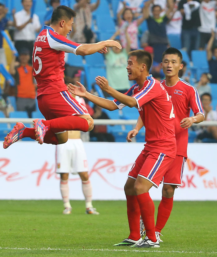  Ri Hyok-chol (left) celebrates in joy with his teammate after successfully scoring the third goal during North Korea's first match in Group F at the Incheon Football Stadium during the Incheon Asian Games on September 15. North Korea defeated China 3-0. (photo: Yonhap News) 