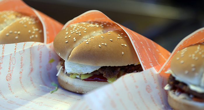 Home-made burgers sell in the streets of Noryangjin. They're made with thick meat patties, fried eggs and carrots.